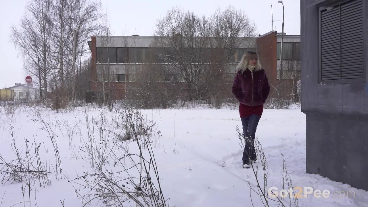 Blonde babe bends over and pees in the snow  